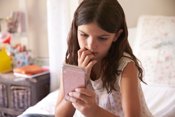 Young Girl In Bedroom Worried